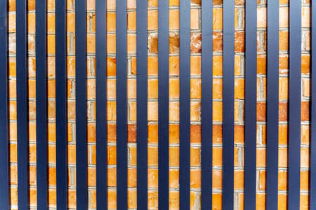 Iron sticks on a brick wall texture background.の写真素材