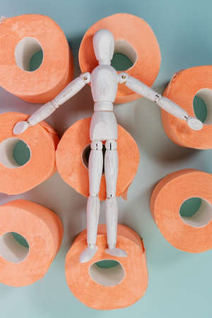 Roll of orange toilet paper on a blue background. hygiene products. flat layの写真素材