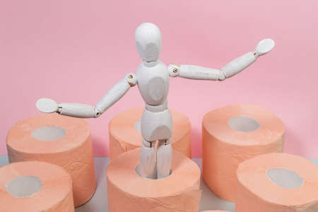 Roll of orange toilet paper on a pink background. hygiene products. copy spaceの写真素材