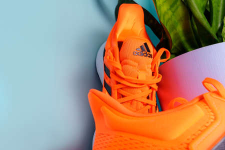 Tyumen, Russia-January 13, 2022: Adidas logo on orange running shoes.のeditorial素材
