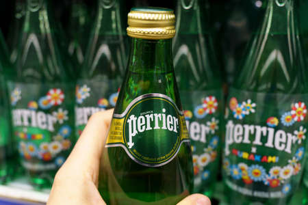 Tyumen, Russia-December 02, 2021: Perrier mineral water bottles on display at a local grocery store.