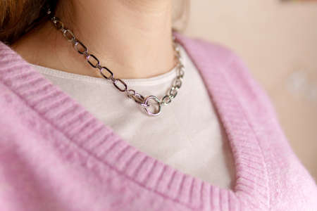 A necklace with chain around the girl's neck. handmade jewelryの写真素材