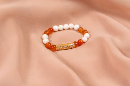 Costume jewelry on agate and carnelian fabric, copy space. E-commerce, online sales and social networks.の写真素材