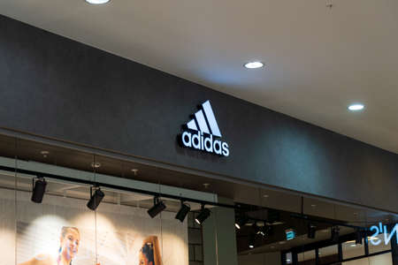 Tyumen, Russia-November 13, 2021: Adidas logo brand and text in front of facade store of sporty fashion clothes.のeditorial素材