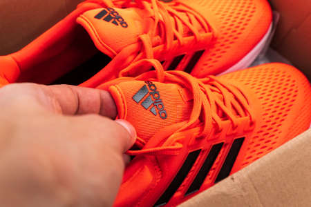 Tyumen, Russia-November 13, 2021: Adidas Running Shoes, orange coral color, eq21 run. close-up