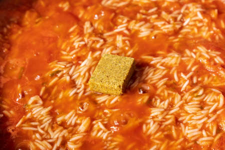 Jollof rice close-up. Background of rice cooked in tomato paste with spices. selective focus