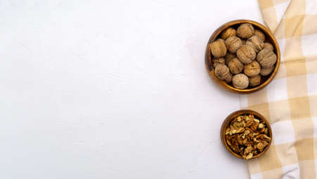 Walnuts in a wooden bowl on a black background with a copy space. view from above. Space for text