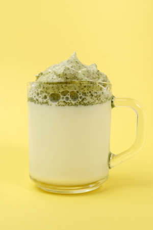 Whipped green tea with milk, dalgona matcha latte in glass. selective focus. Korean drink. vertical...