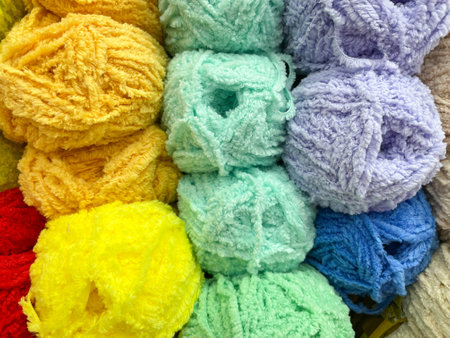 Multi colored balls of yarn for knitting. Woolen threads for needlework. Texture