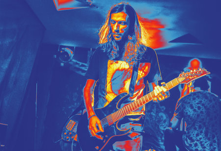 Rock musician on stage retro style rock music man with long hair. Thermography gradients, retro...