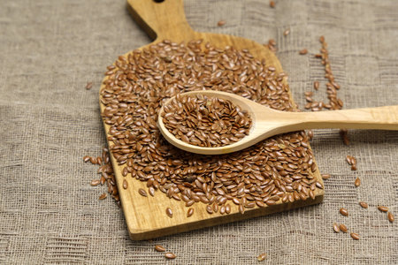 Brown flux seed background. Flaxseed oil preparation. Flax oil is rich in omega-3 fatty acids.の写真素材