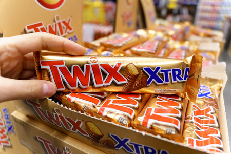 Tyumen, Russia-January 26, 2023: Twix candy bars xtra. Illustrative editorial photography. Blurred shelf of grocery store in the background.のeditorial素材