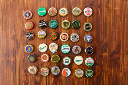 Tyumen, Russia-February 15, 2023: Metal colorful collection of used beer crowns caps, top view.のeditorial素材
