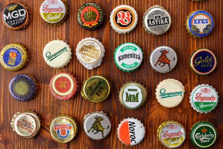 Tyumen, Russia-February 15, 2023: Metal colorful collection of used beer crowns caps, top view.