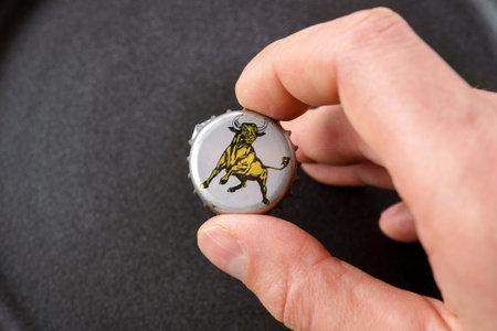 Tyumen, Russia-February 15, 2023: Lid of a glass bottle with the image of a bull, red bull old logo. The most popular energy drink in the world.のeditorial素材