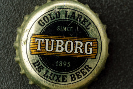 Tyumen, Russia-February 15, 2023: Tuborg beer, produced by a Danish brewing company. Old beer lid, macroのeditorial素材
