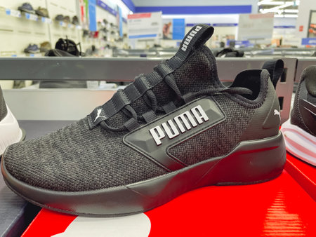 Tyumen, Russia-January 23, 2023: New Puma shoes, sneakers, trainers showing the logo. Sport and casual footwear concept.のeditorial素材