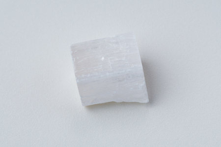 White selenite, variety of the mineral gypsum, zen meditation stones, white background