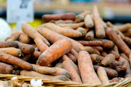 Sale of carrots in a grocery hypermarket. Pile of carrots background. Grocery store.の写真素材