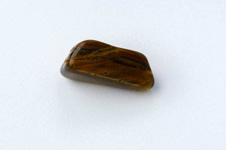 Natural mineral stone tiger eye gemstone. On a white background.の写真素材