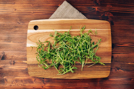 Green arugula top view. A healthy food supplement containing vitamins. wooden backgroundの写真素材