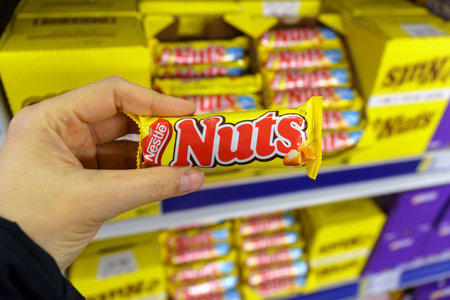Tyumen, Russia-March 22, 2023: Nuts chocolate bar from the Nestle company. Grocery store shelvesのeditorial素材