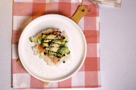 Sushi Waffle is crispy rice, made in a waffle maker, topped with shoyu salmon, crunchy cucumber. flat layの写真素材