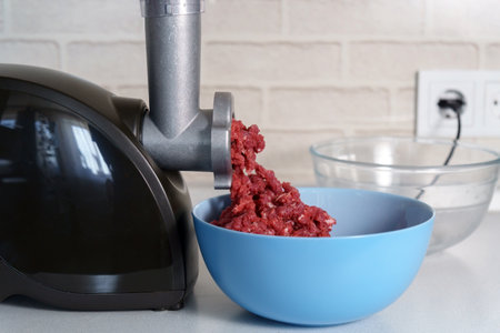 Preparation of minced meat in an electric meat grinder. selective focus.の写真素材