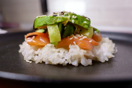 Sushi waffles are crispy rice cooked in a waffle iron, with salmon crunchy cucumber, and avocado.の写真素材