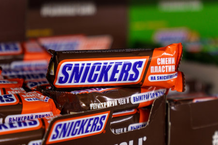 Tyumen, Russia-March 17, 2023: Snickers bar is a chocolate bar with caramel and peanuts, manufactured by Mars, Incorporated.のeditorial素材