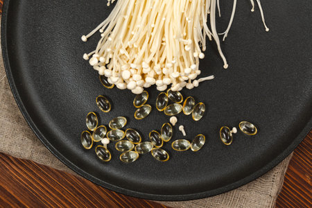 Mushroom or enoki close up, enokitake Flammulina velutipes. capsules, dietary supplements.の写真素材