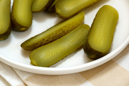 Pickled cucumbers close-up, snack. selective focus. Ingredients for cooking on a wooden table.の写真素材