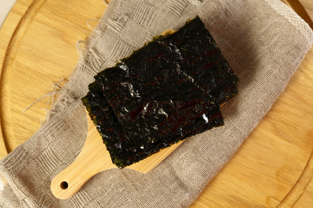 Green dry Nori seaweed leaf texture circle rotation close up. Healthy snack. selective focus