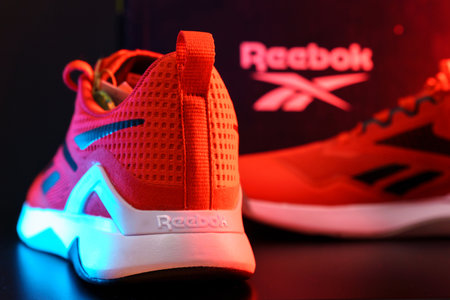 Tyumen, Russia-August 03, 2023: Reebok mens model Nanoflex in the red, blue light. Selective focusのeditorial素材
