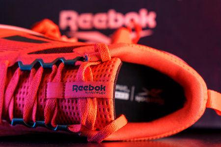 Tyumen, Russia-August 03, 2023: Stylish red Reebok footwear for sports. Multicolored light. Selective focusのeditorial素材