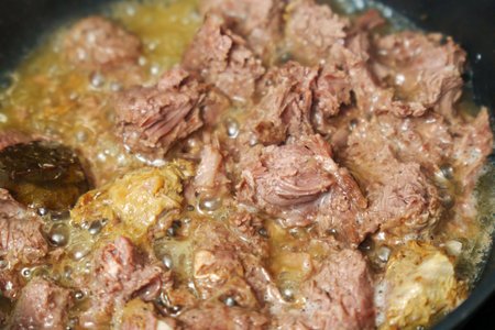 Cooking stewed canned meat in close-up. Canned foodの写真素材