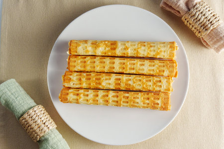 Ethereal Morning Delight: A Gourmet Stack of Golden Waffles on a Crisp White Plateの写真素材