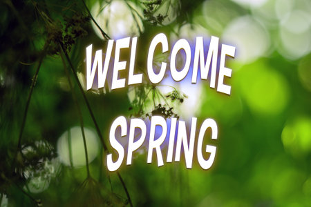 Green blurred background with white text Welcome spring. Selective focus