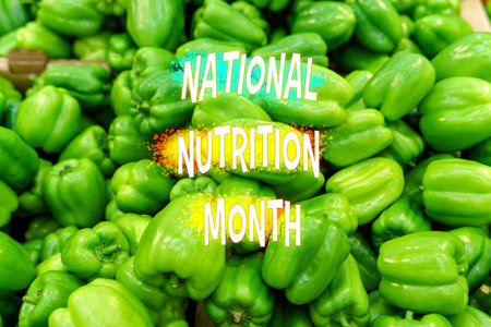 Fresh bell peppers capture the essence of National Nutrition Month, promoting healthy eating and...