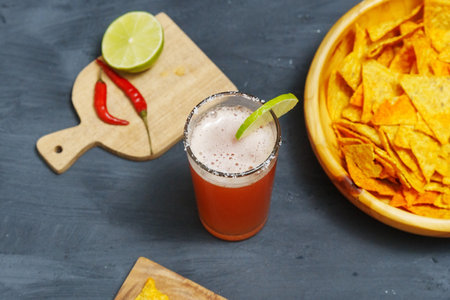 Mexican cocktail, michelada, made with beer and tomato juice. Selective focusの写真素材