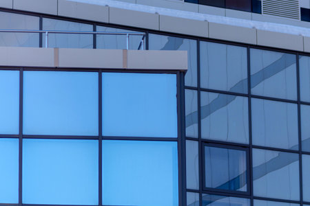 Towering building adorned with countless windows, creating a mesmerizing sight against the urban...