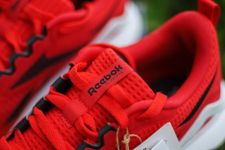 Tyumen, Russia-June 20, 2024: Reebok red sneakers logo. Reebok is a global athletic footwearのeditorial素材