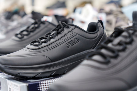 Tyumen, Russia-August 11, 2024: Close-up of a Fila sneaker showcasing the intricate lacing and design in a retail storeのeditorial素材