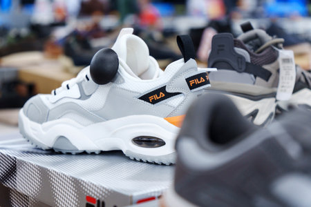 Tyumen, Russia-August 11, 2024: Close-up of a Fila sneaker showcasing the intricate lacing and design in a retail storeのeditorial素材