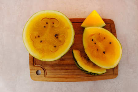 Delicious yellow watermelon sliced open to reveal its vibrant, sweet interior, perfect for summerの写真素材