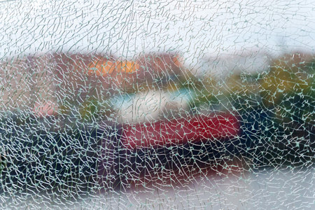 A close-up view of fragmented glass creating an abstract texture while hinting at a vibrant...