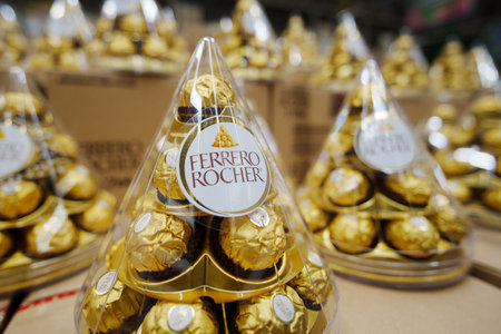 Tyumen, Russia-November 02, 2024: Ferrero Rocher chocolate stacking in bulk in Mercato grocery storeのeditorial素材
