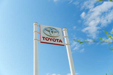 Tyumen, Russia-August 10, 2024: prominent dealership sign features the Toyota logo against a bright blue skyのeditorial素材