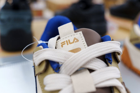 Tyumen, Russia-August 11, 2024: Close-up of a Fila sneaker showcasing the intricate lacing and design in a retail storeのeditorial素材