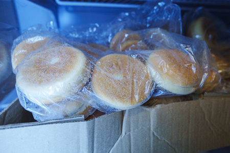 Frozen hamburger buns in the fridge. Selective focus